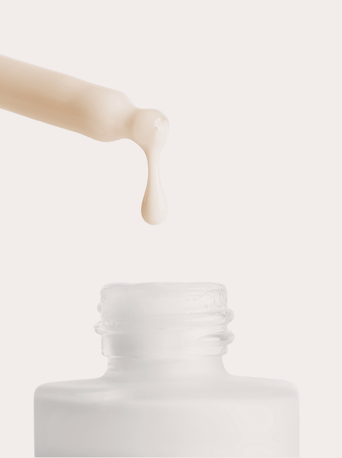 Active Recovery Serum dropper releasing a drop above the bottle